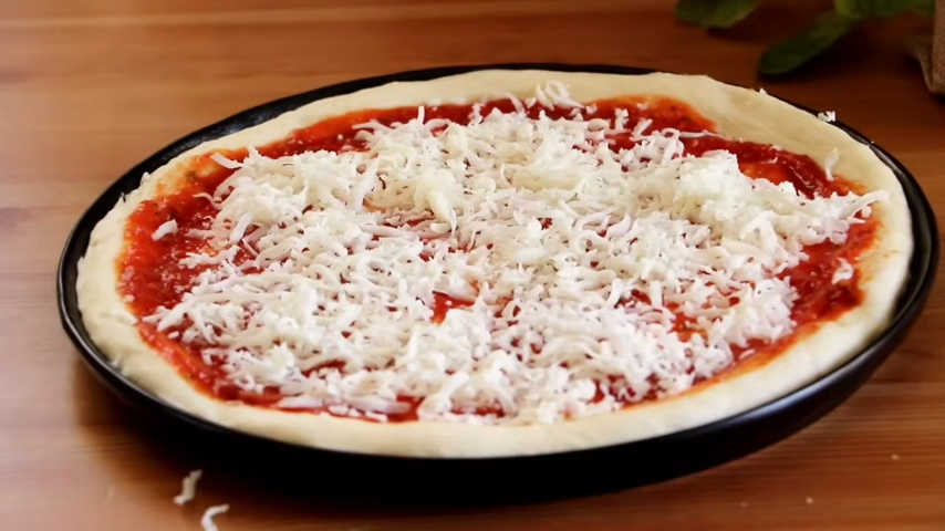 pizza dough add sauce, and cheese